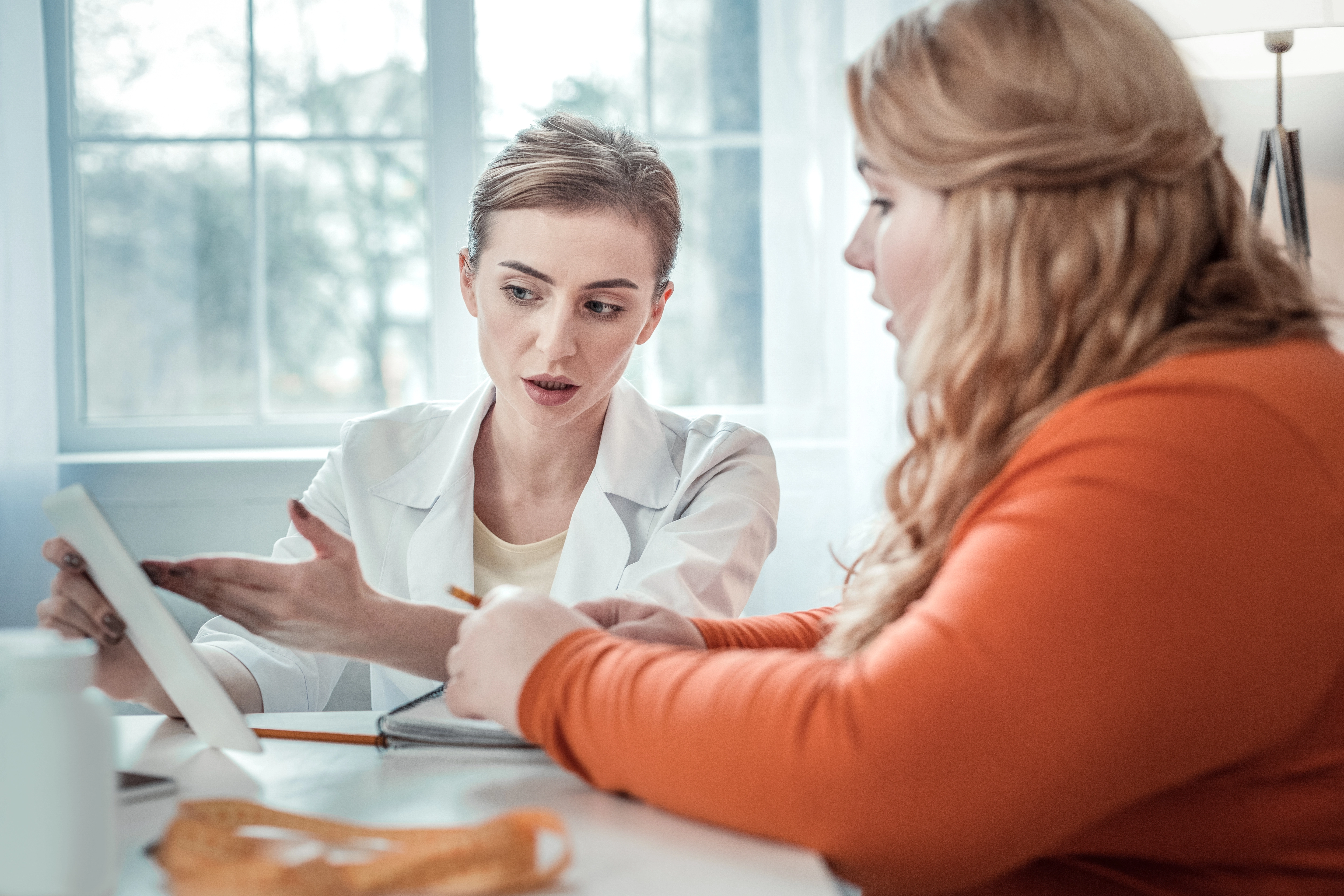 Image suggestion: a provider reviewing lab results with a patient in a bright exam room, illustrating the testing that guides a medical weight loss plan.