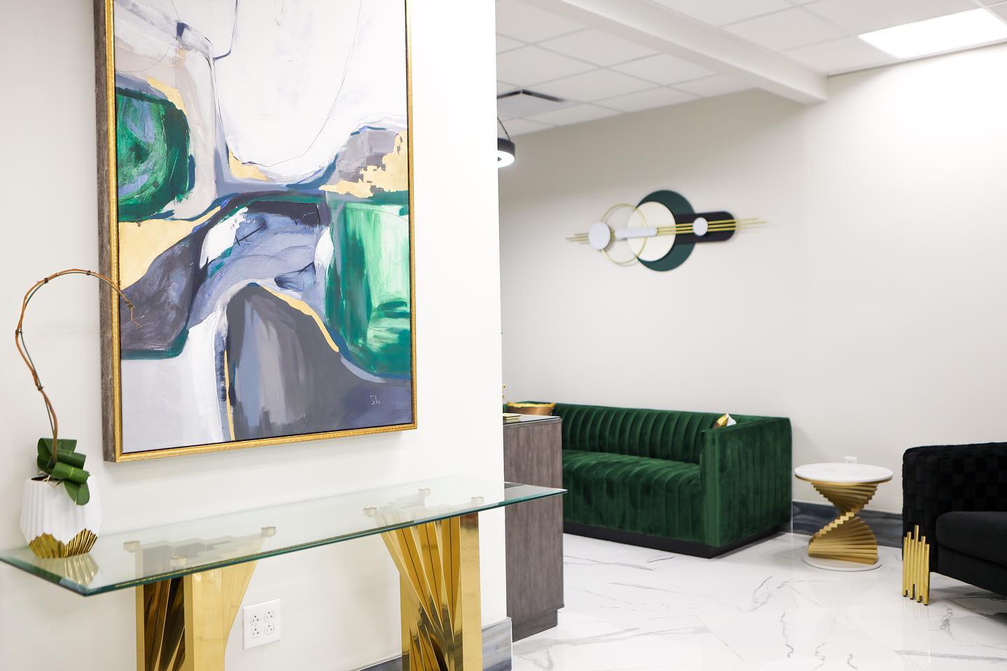 VIA Health & Medspa lobby in Chandler with a green velvet sofa and abstract artwork