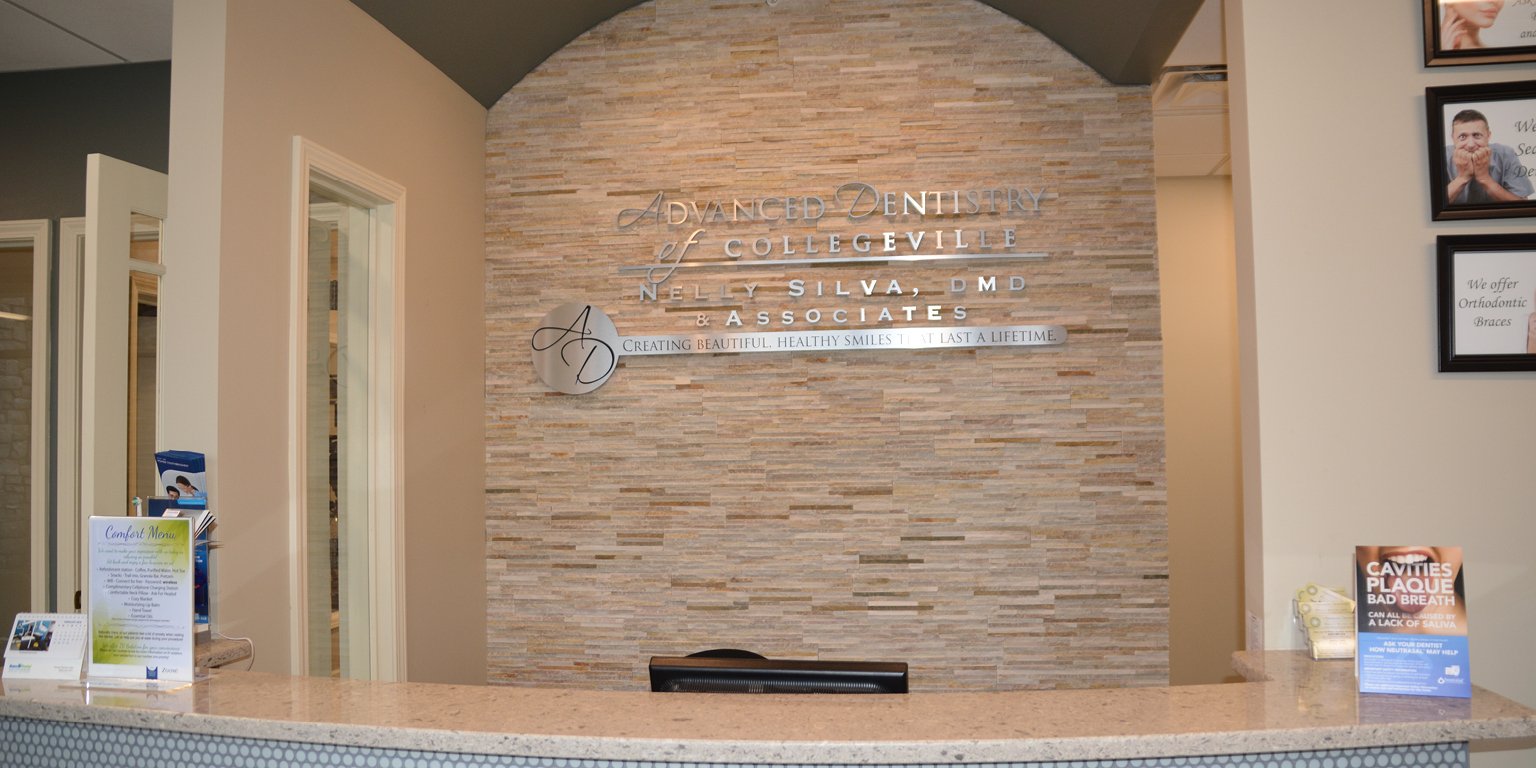 Front reception desk with our practice sign on a stacked stone wall