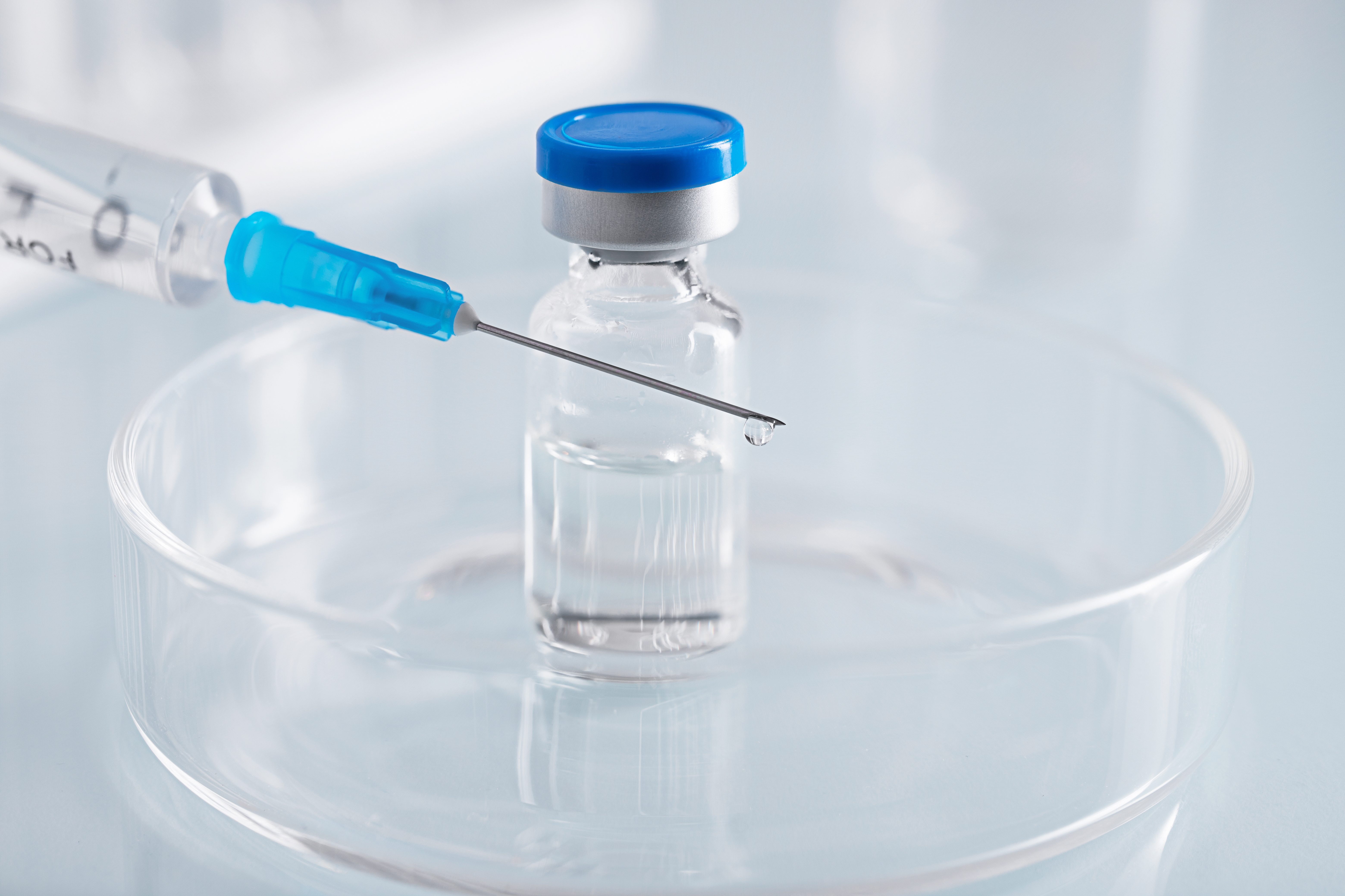 Close-up stock photo of a syringe drawing liquid from a medication vial, used as a banner for an article on peptide therapy