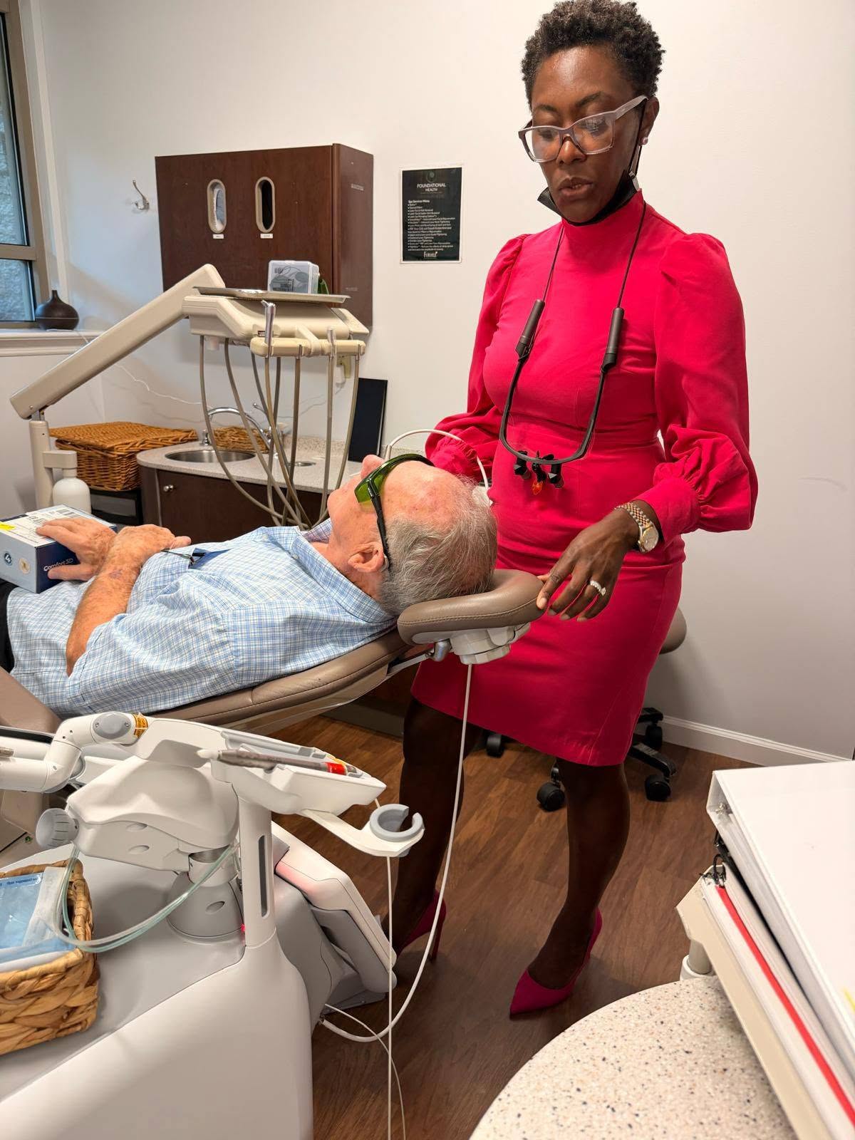 Dr. Nelly Silva checking on a patient in a treatment chair at our Collegeville dental office