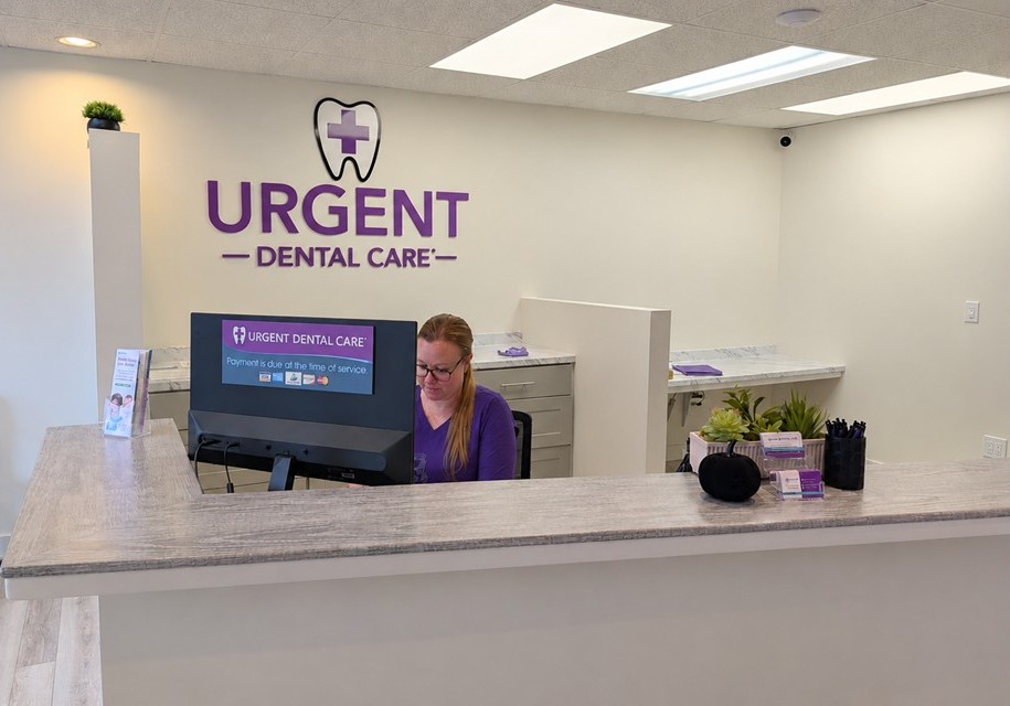 patient checking in at a dental office reception desk