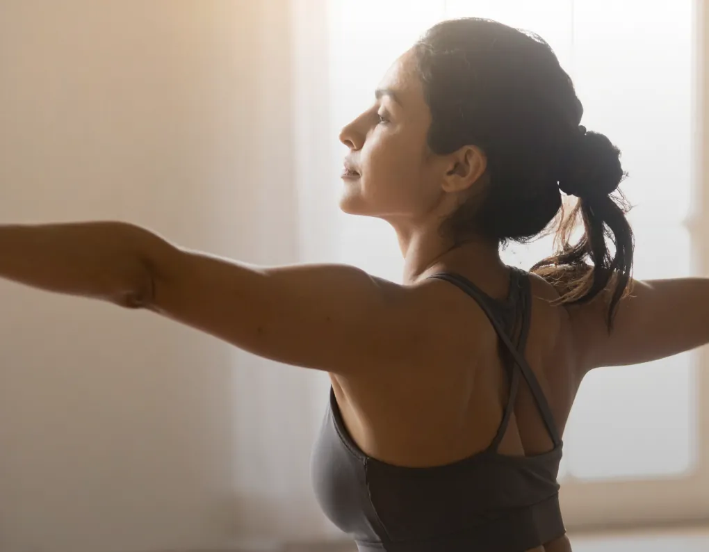 A woman stretching in a bright studio