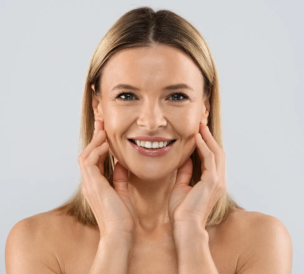 Smiling woman touching her smooth face with both hands