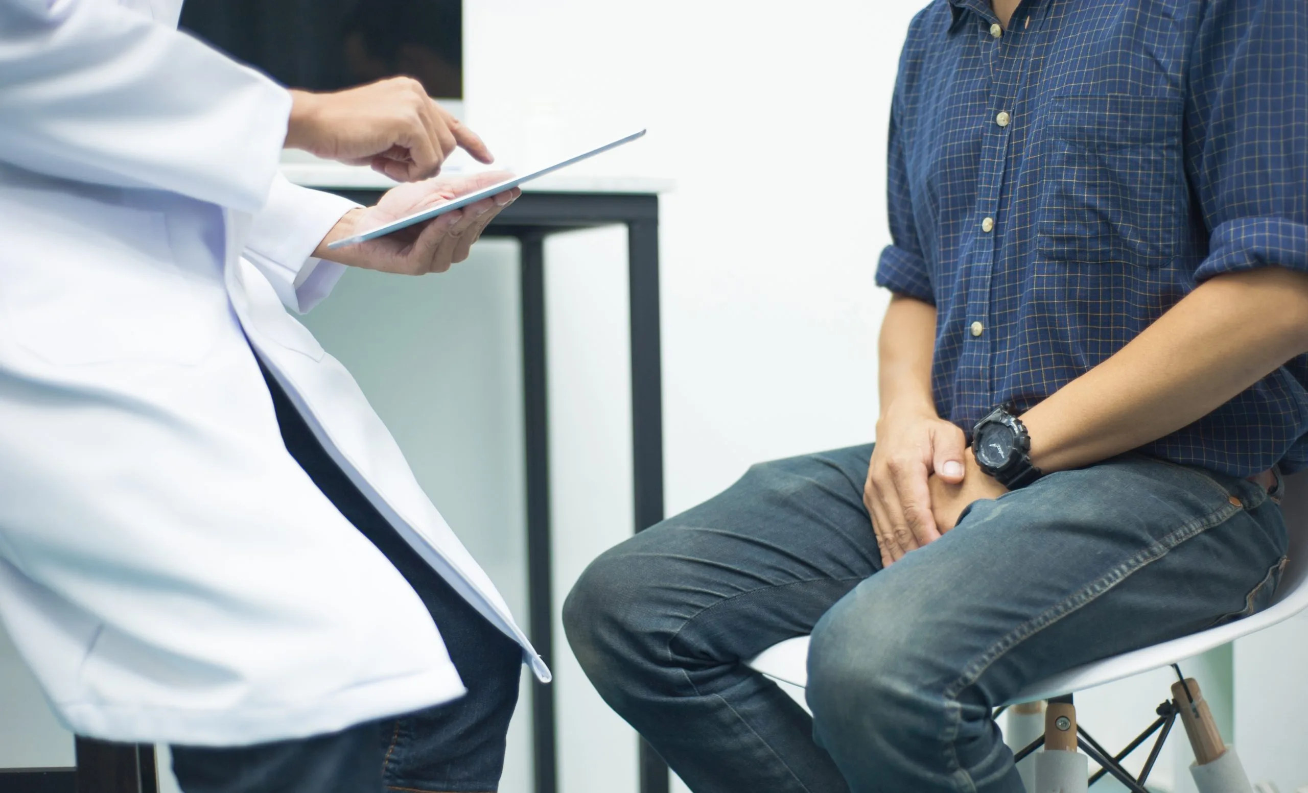 Doctor consulting a male patient in a medical office.