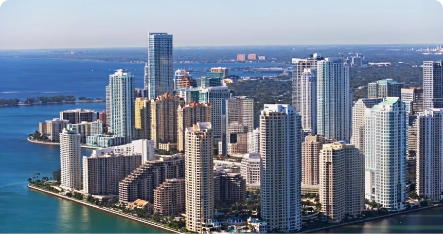 Aerial view of Miami skyline with beachfront high-rises along Biscayne Bay