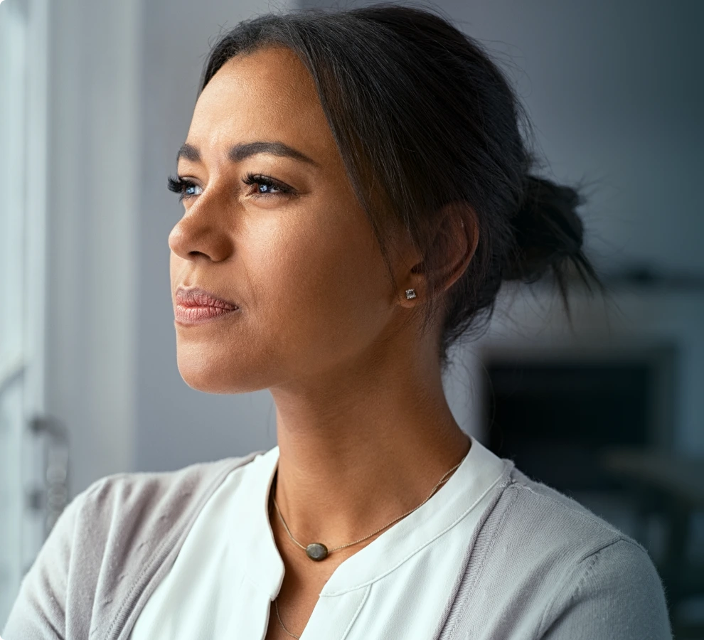 Woman in profile looking thoughtful in a therapy office setting at Archway Psychotherapy, Olathe, KS