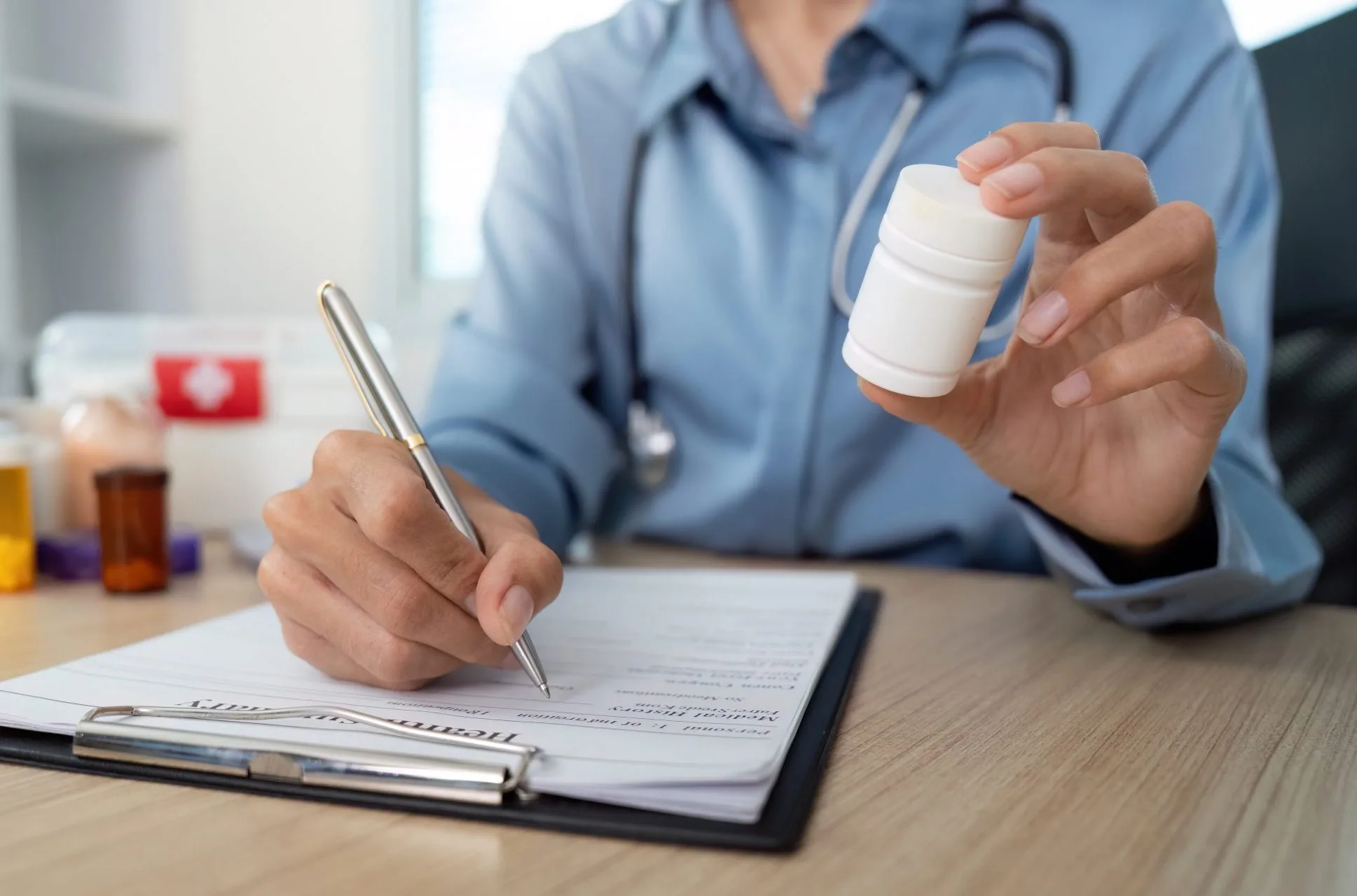 Psychiatric provider reviewing a prescription with a patient during a medication management visit at Archway Psychotherapy in Olathe, KS