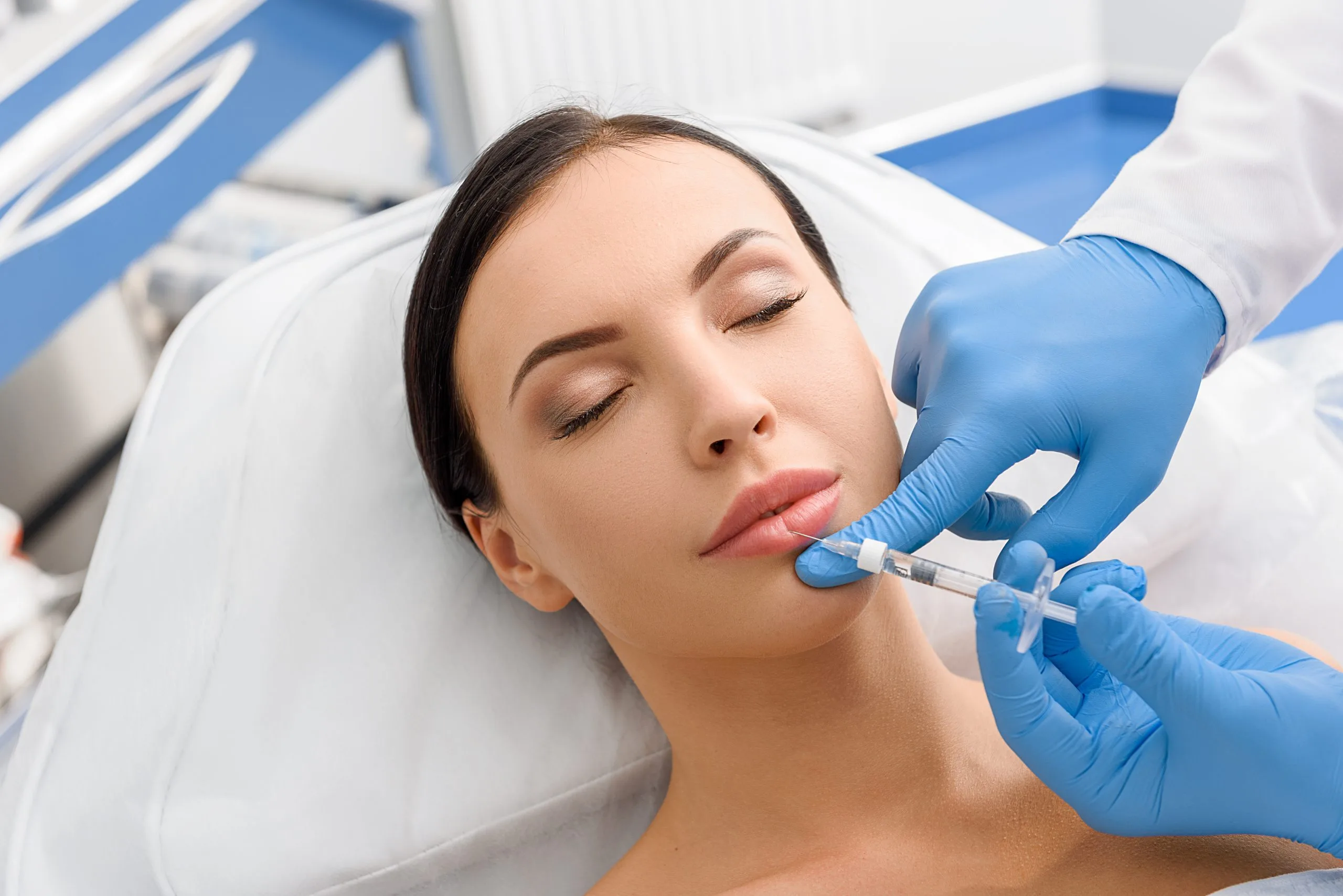Healthcare provider administering dermal filler injection to patient's lips