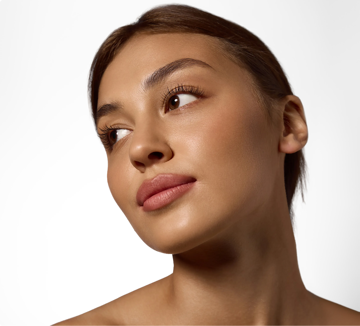 Woman looking upward with glowing complexion