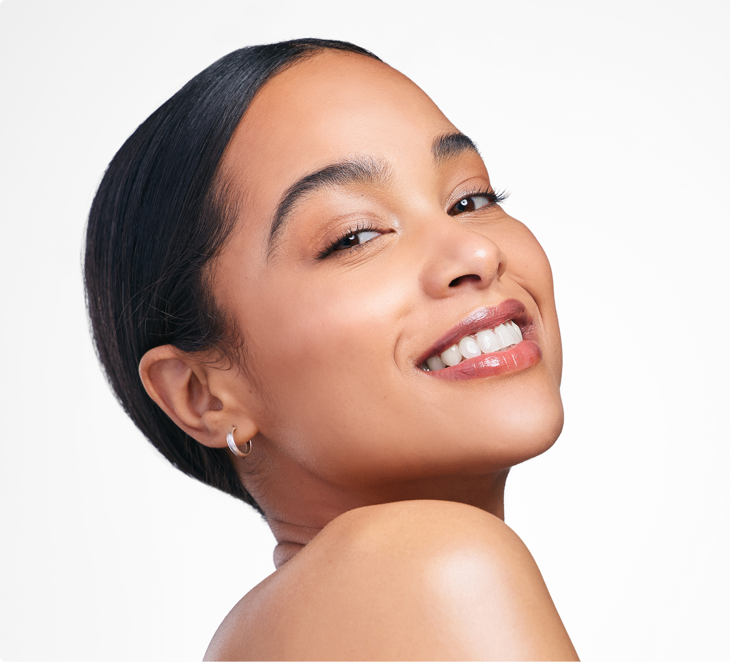 Woman smiling at camera with radiant skin