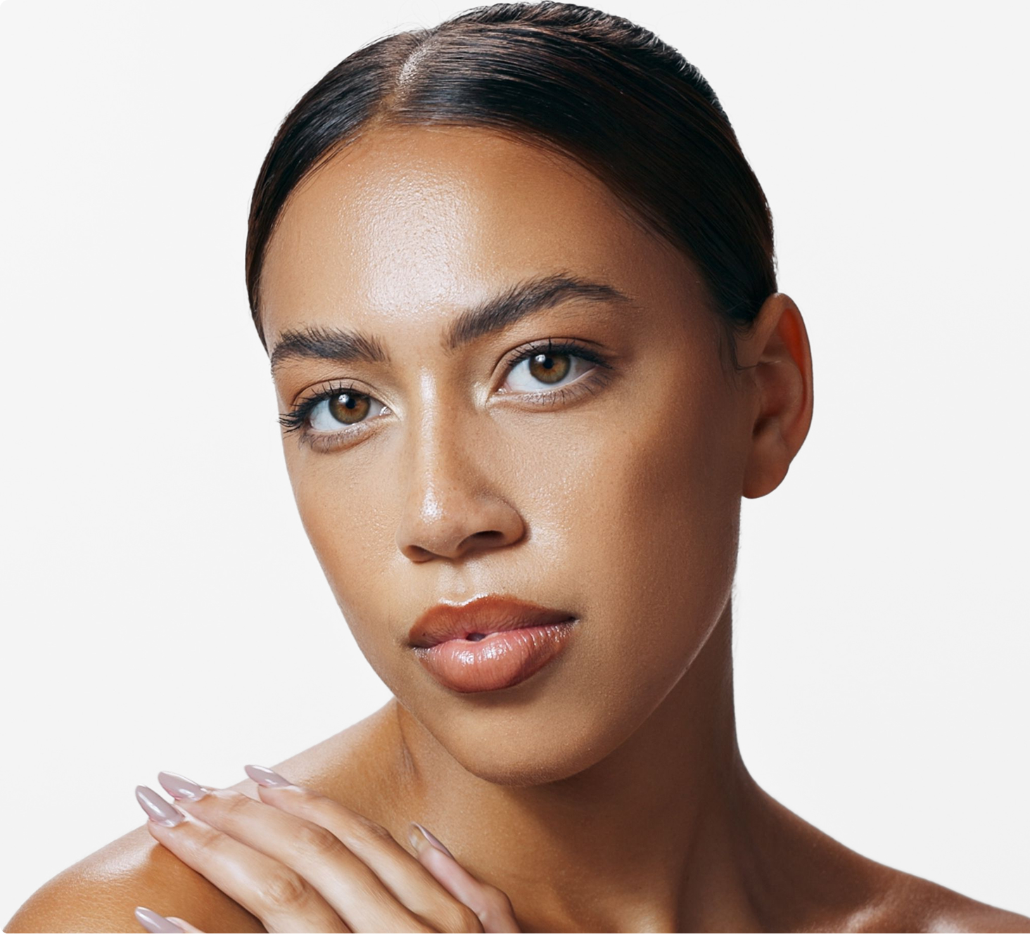 Woman with clear skin and defined eyebrows looking toward camera