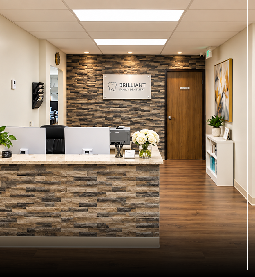 Brilliant Family Dentistry reception area with stone accent wall, front desk, and logo sign