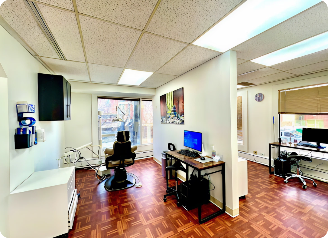 Brilliant Family Dentistry's modern dental operatory with treatment chair, computer workstation, and city views from large windows