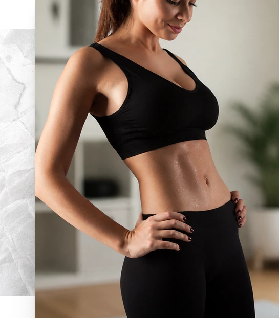 Woman displaying a toned, flat abdominal profile after tummy tuck results