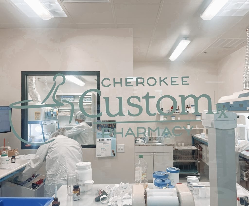 Compounding lab behind the Cherokee Custom Script Pharmacy window, serving patients in Cumming, GA