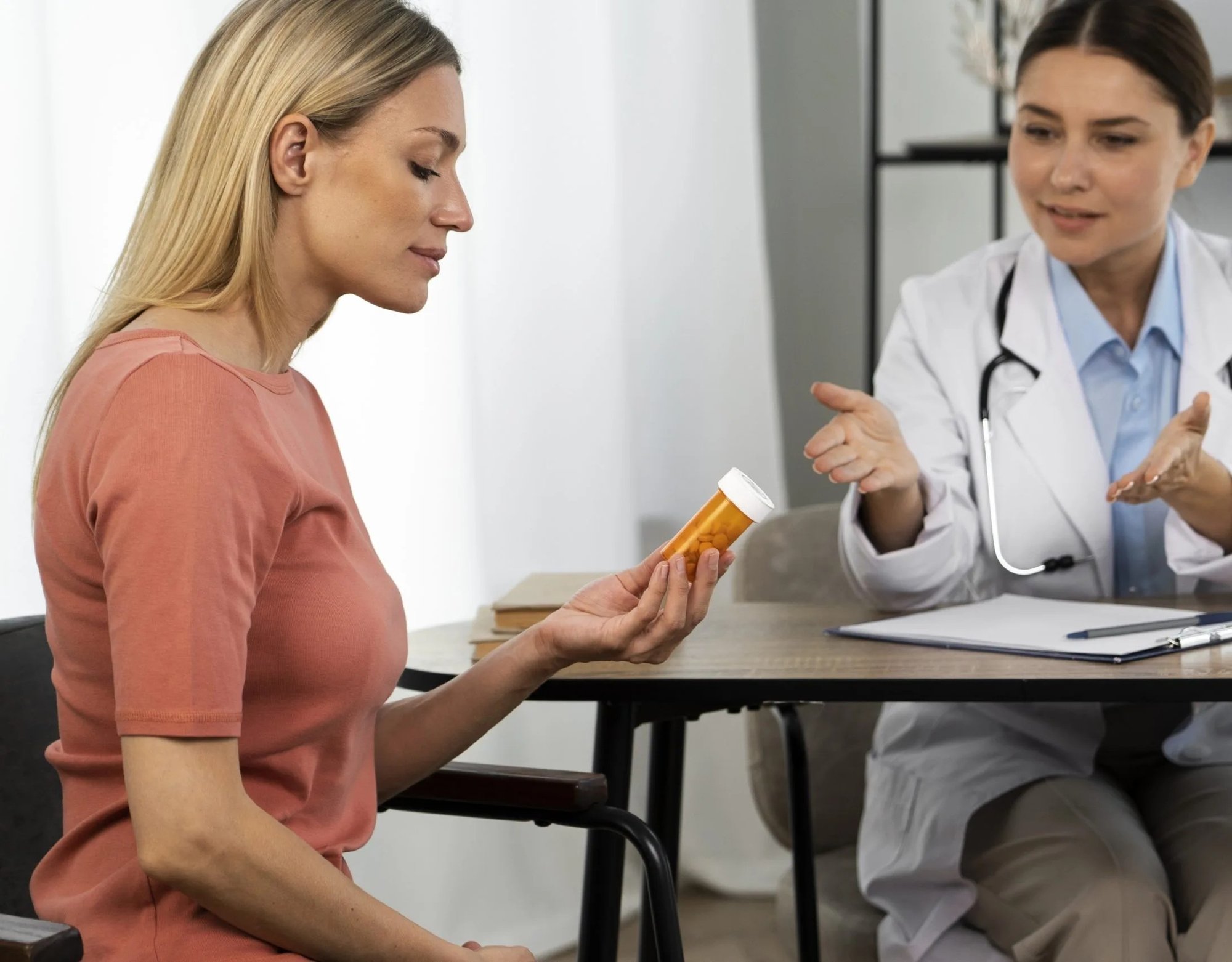 Patient holding a prescription bottle while a provider explains how to take the medication