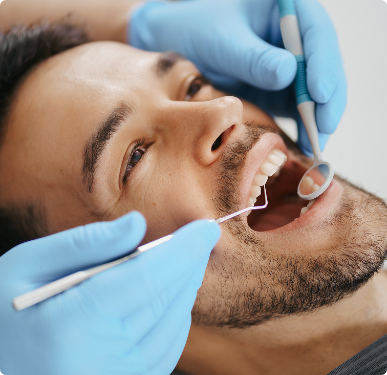 Dentist examining a patient's lower jaw and teeth during ridge augmentation consultation
