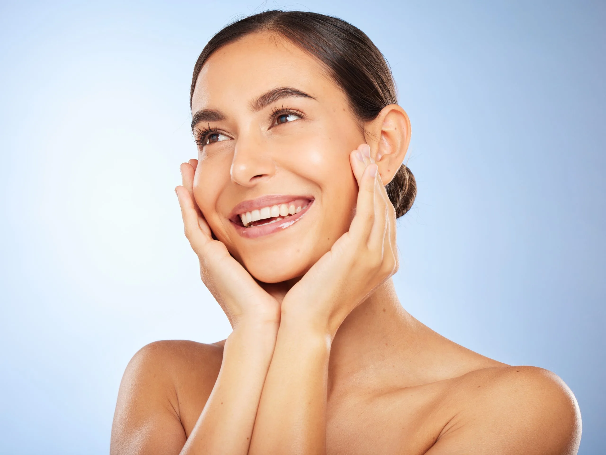 Woman smiling confidently after sinus lift and implant surgery at Cherry Creek Oral Surgery
