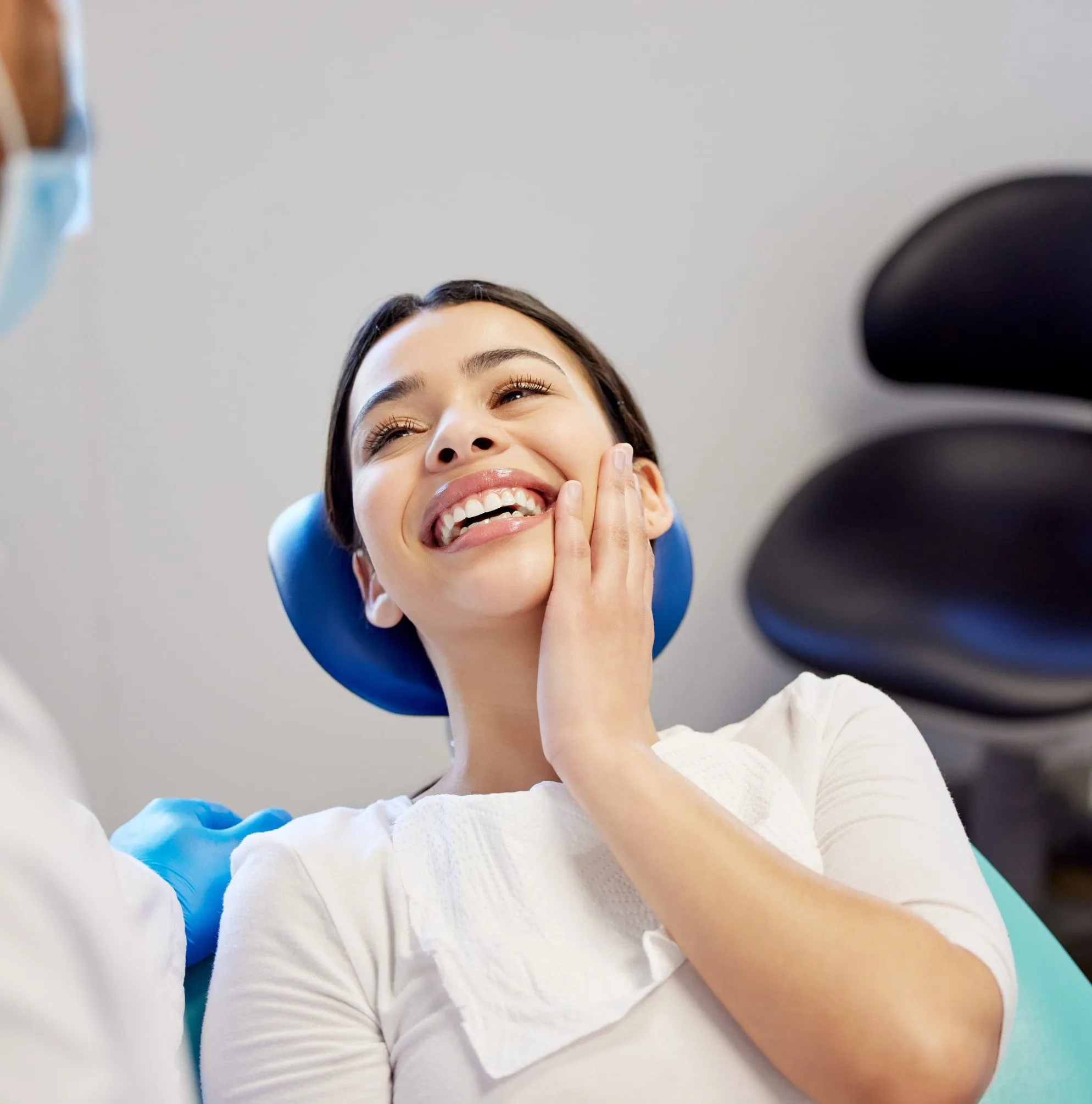 Patient smiling with her oral surgeon after socket preservation treatment at Cherry Creek Oral Surgery in Denver