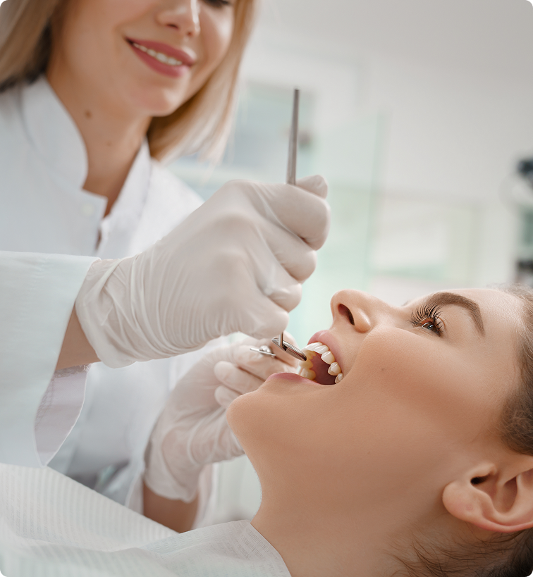 Dentist examining a patient's mouth during a dental procedure