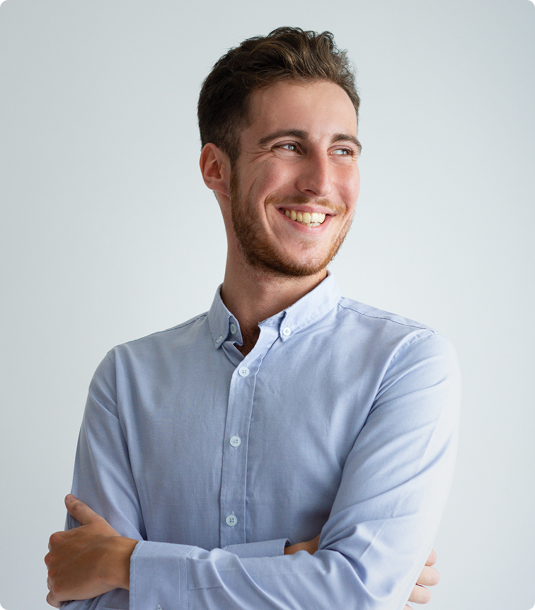 Man smiling at camera in light blue button-up shirt against neutral background