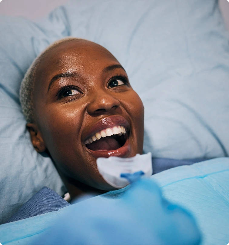 Patient smiling in dental chair during PRP treatment consultation in Denver