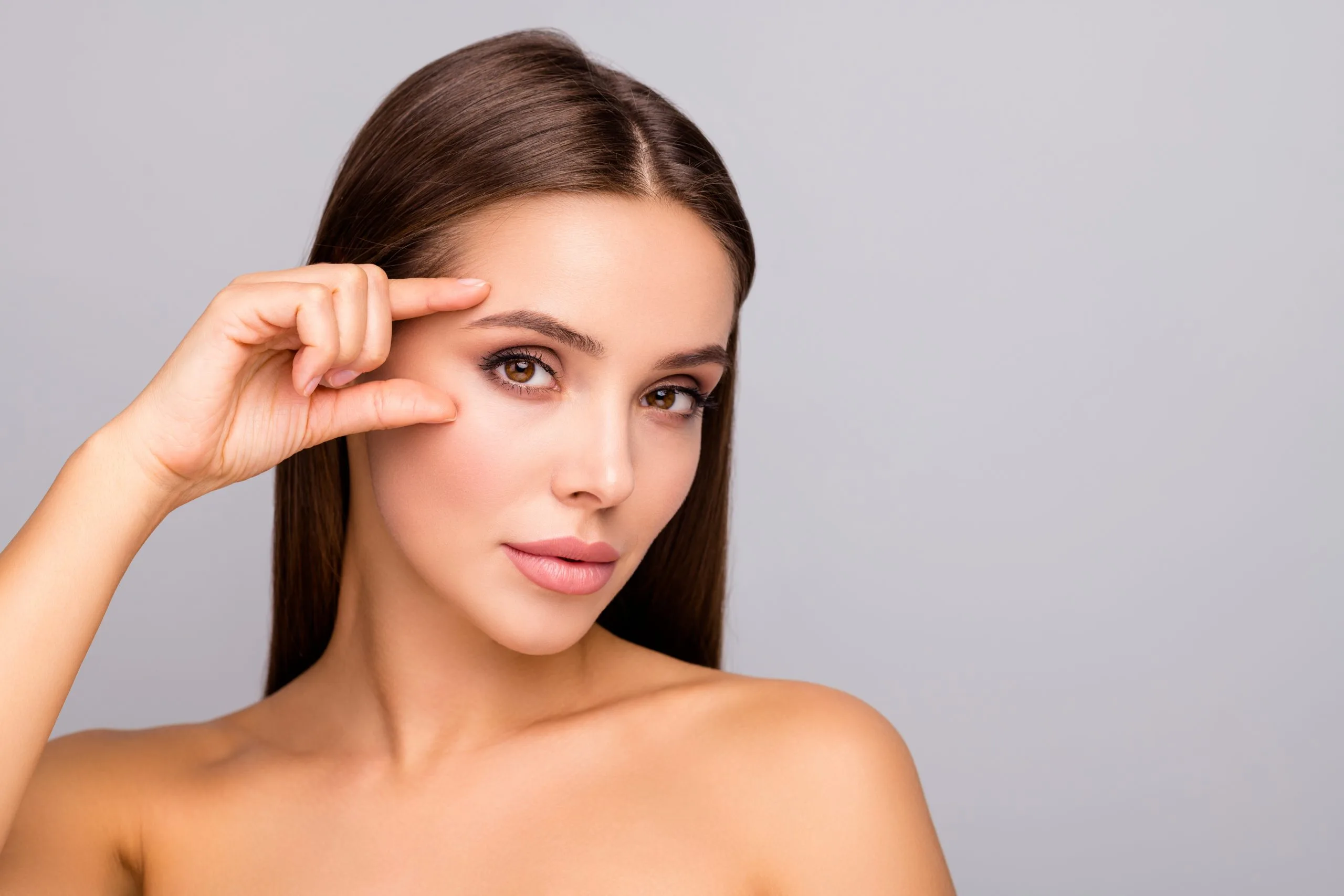 Woman examining her facial skin and texture