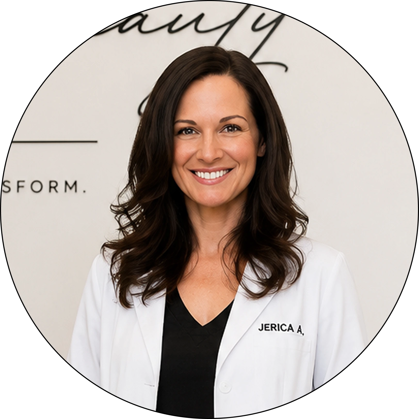 Jerica A., team member wearing white coat with black v-neck top, smiling at camera