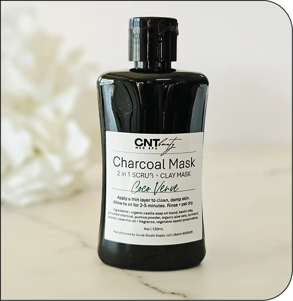 CNT Medspa Charcoal Mask 2-in-1 scrub and clay mask bottle with aloe vera on marble surface