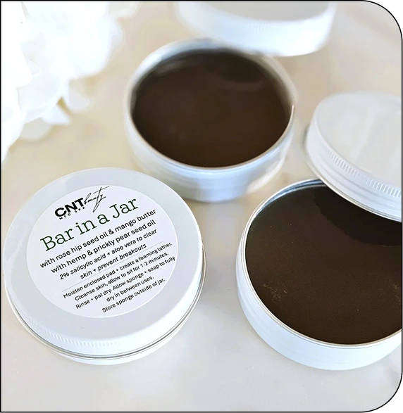 CNT Medspa Bairn Tar product jars with black charcoal formula and ingredient label visible