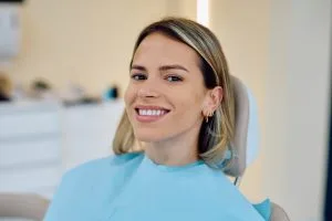Smiling adult patient in a dental chair during a general dentistry visit