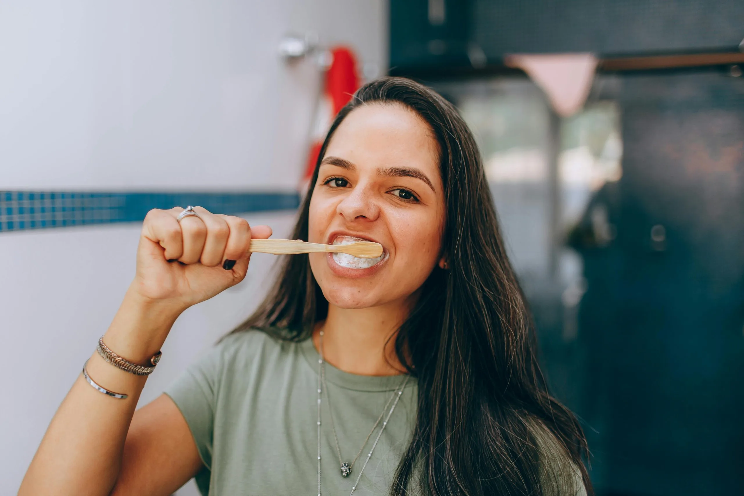 Young woman brushing her teeth in a bathroom