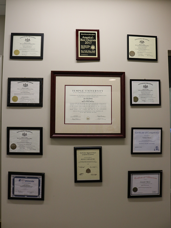 Wall of Dr. Silva’s diplomas and credentials in the office