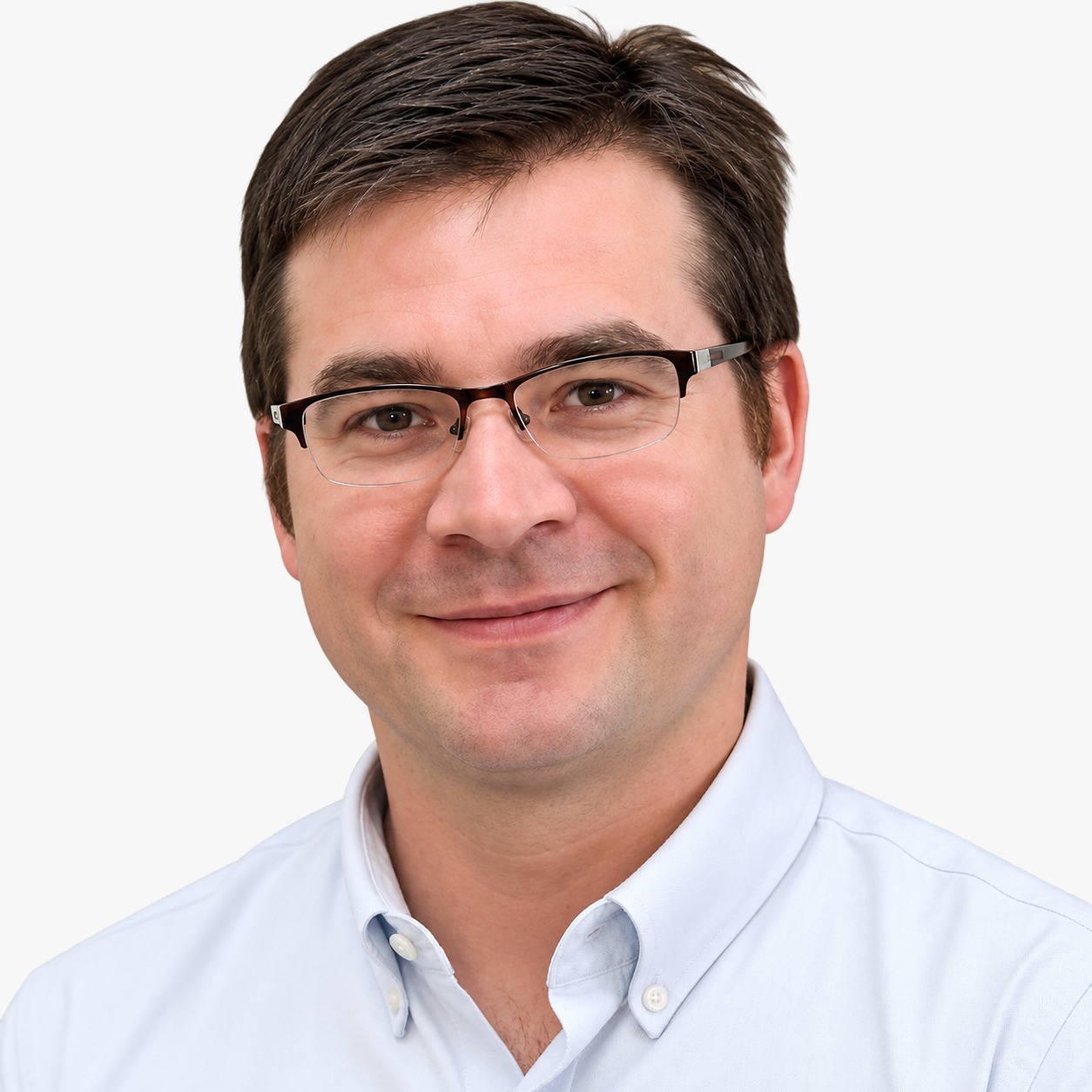 Professional headshot of a male provider wearing glasses and a light blue shirt