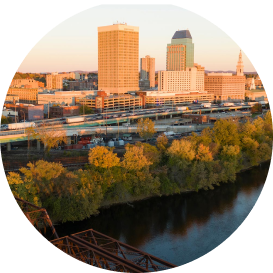 Danbury, CT skyline with riverside buildings and golden autumn foliage