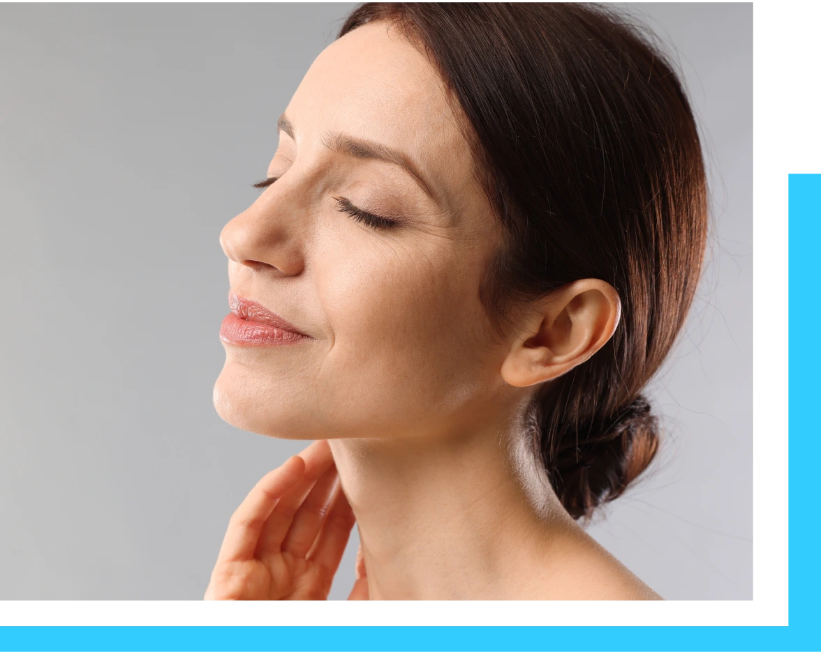 Woman in profile touching her neck and jawline, demonstrating skin firmness