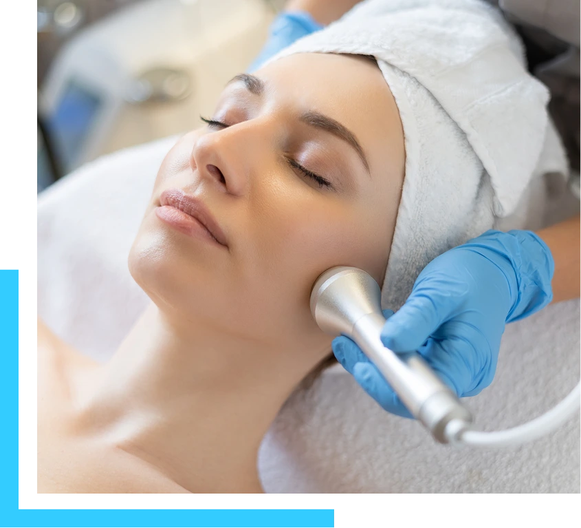 Patient receiving non-surgical skin tightening treatment with handheld device on face