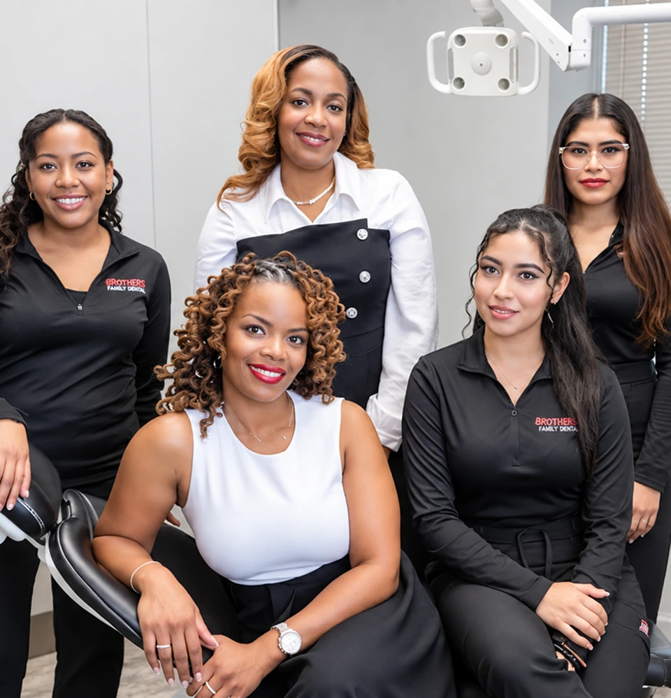 Dentcare Now team members posing together in a dental treatment room