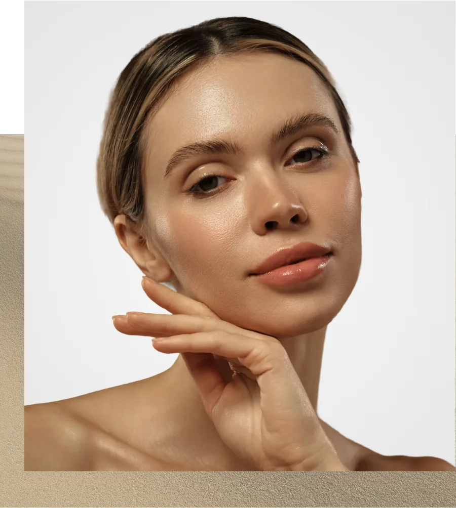 Woman touching her face with hand, looking at camera against neutral background