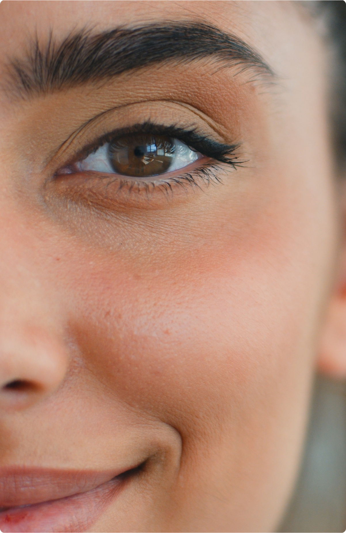 Close-up of a woman's eye and brow showing defined eyelid contour and smooth skin texture