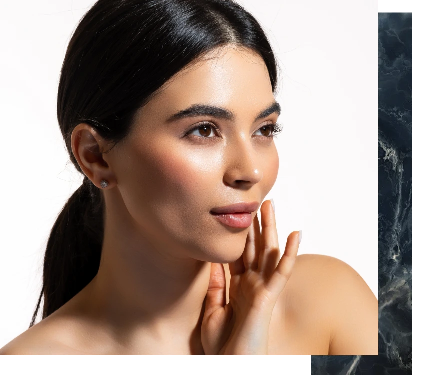 Woman touching her face, showcasing smooth, radiant skin