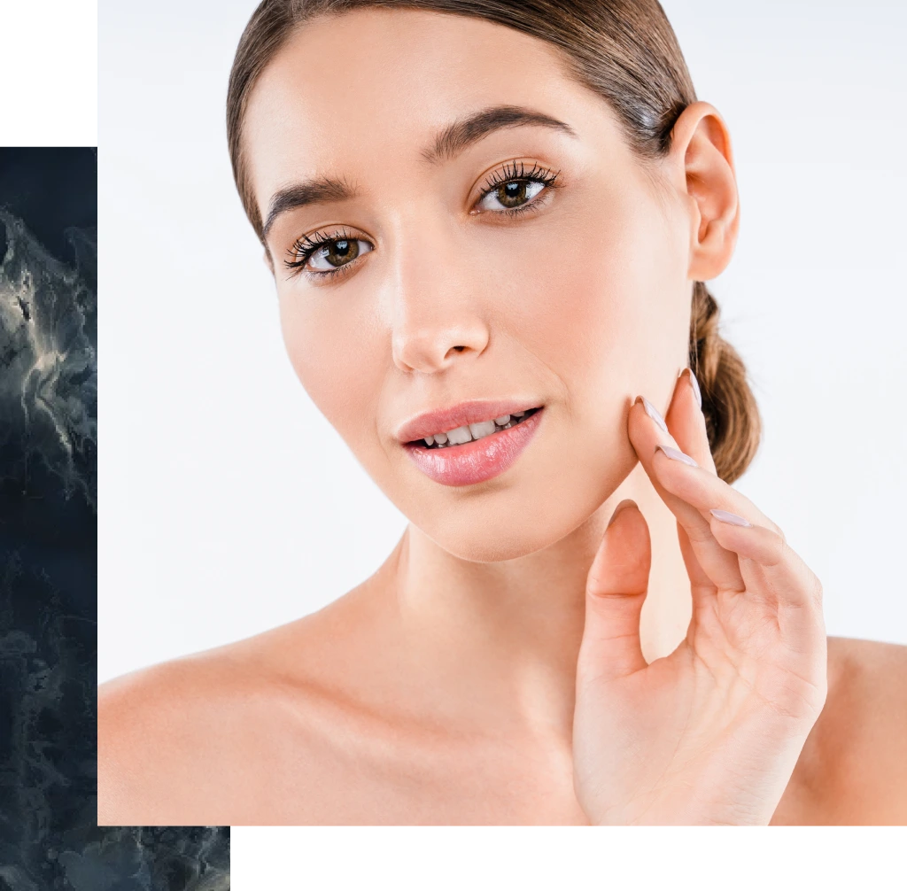 Woman touching her cheek, demonstrating smooth, radiant skin after dermaplaning treatment
