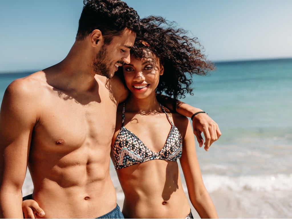 Illuum couple walking on beach