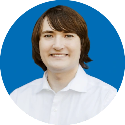 Cole Scanlon, team member, smiling portrait against blue background