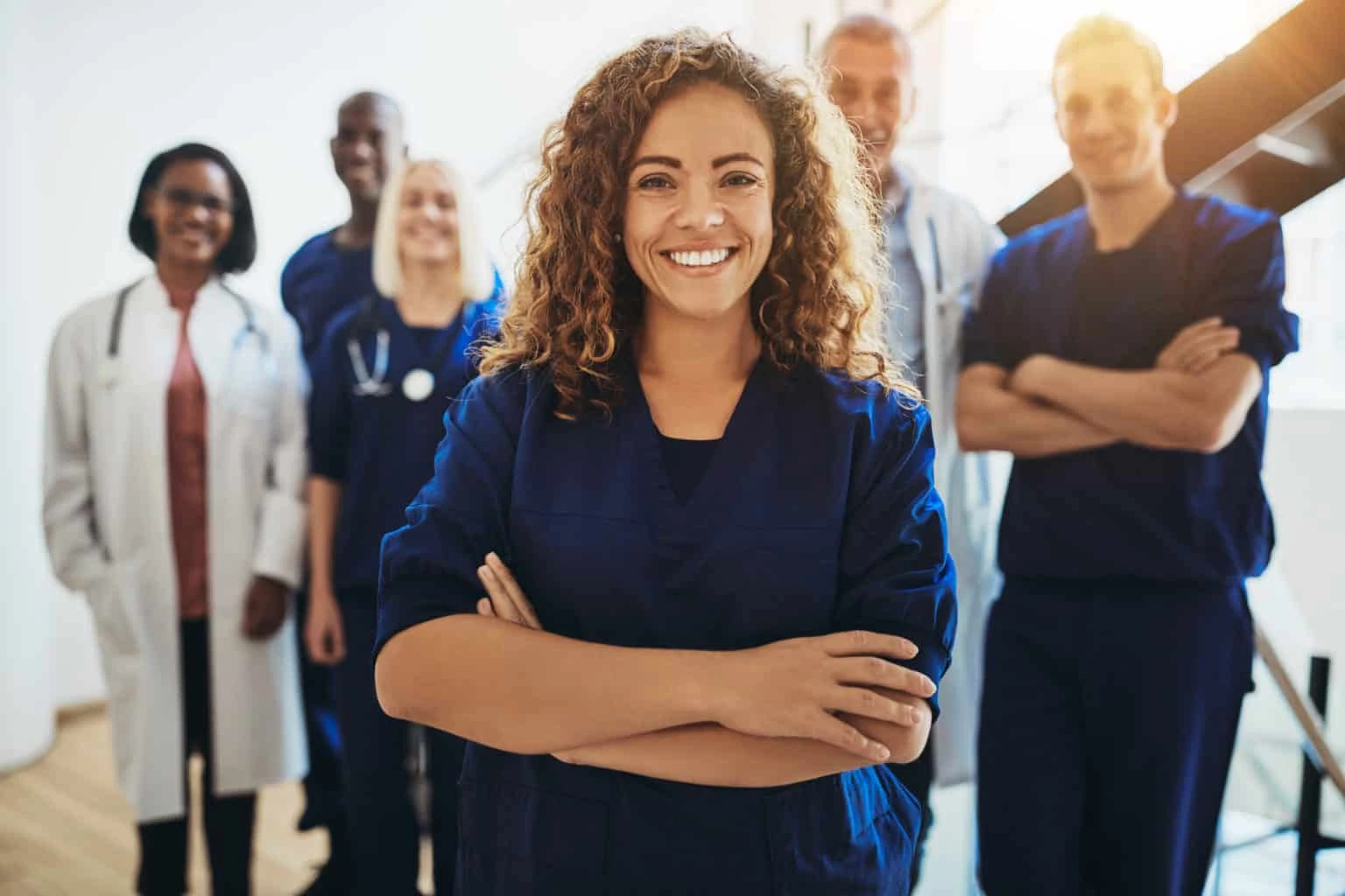 Diverse healthcare team standing together, representing Labor Day, meaningful work, and the importance of rest