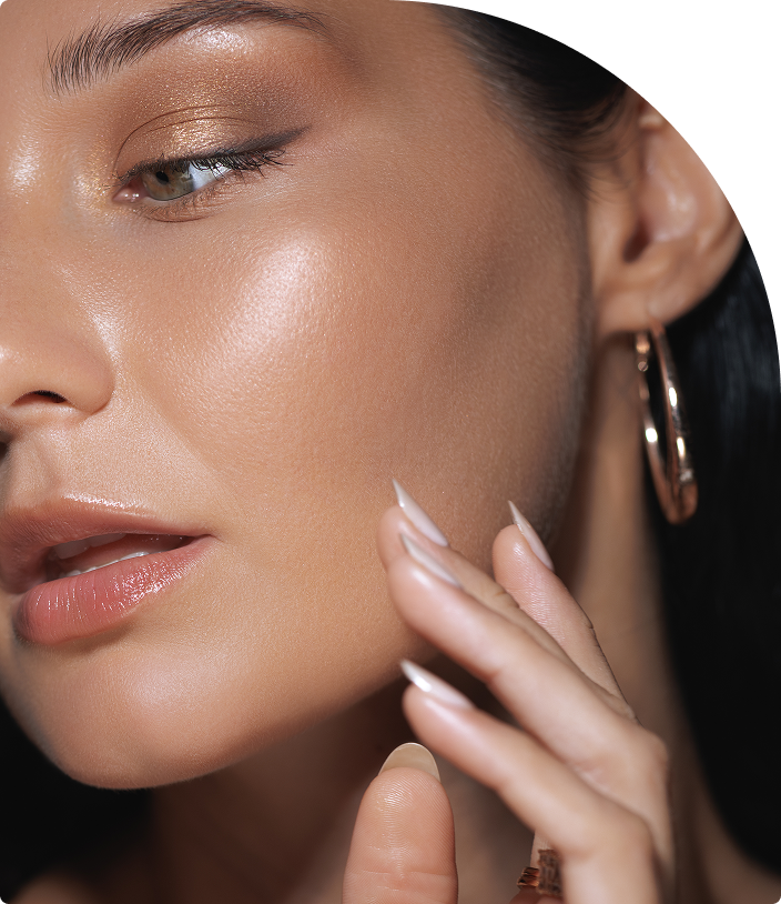 Woman with glowing skin touching her cheek, demonstrating complexion results