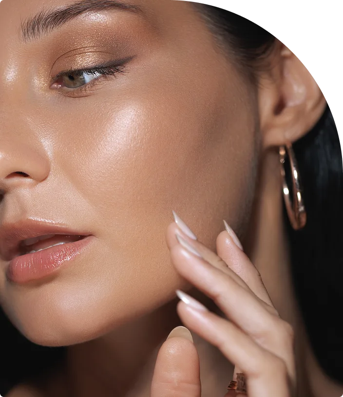 Woman with glowing skin touching her cheek, demonstrating complexion results