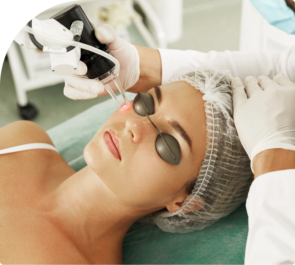 Aesthetician performing CO2 laser resurfacing on patient's face with protective eyewear