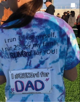 Girl wearing a shirt Dad written on it Social media